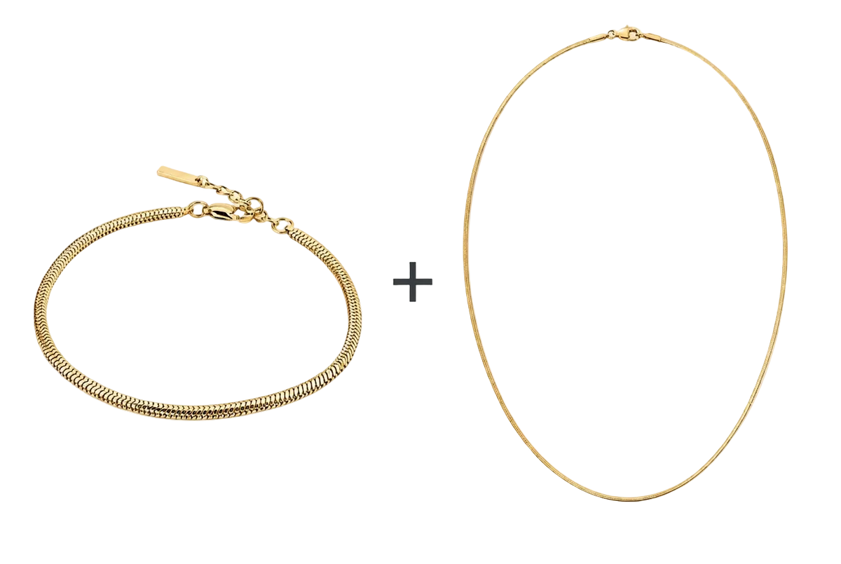 Goudkleurige VIBE-armband en ketting met een plusteken ertussen op een witte achtergrond