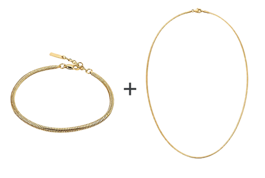 Goudkleurige VIBE-armband en ketting met een plusteken ertussen op een witte achtergrond