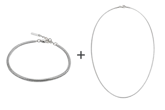 Zilverkleurige VIBE-armband en ketting met een plusteken ertussen op een witte achtergrond